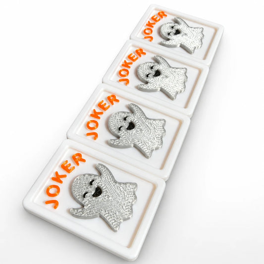 Four Spools mahjong joker tiles with raised 3D silver smiling ghosts and orange JOKER lettering in white framed tiles
