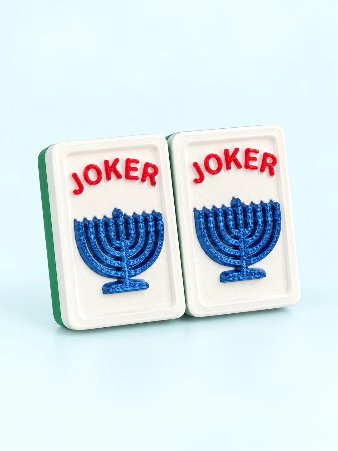 Two Hanukkah menorah joker mahjong tiles with a blue menorah under red JOKER lettering, by Spools