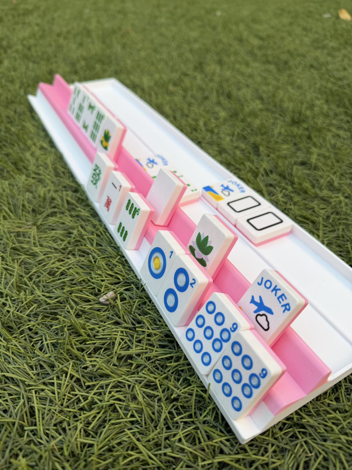 Detail view of a Two Player travel rack holding 28 tiles, showing the compact 3D-printed design.