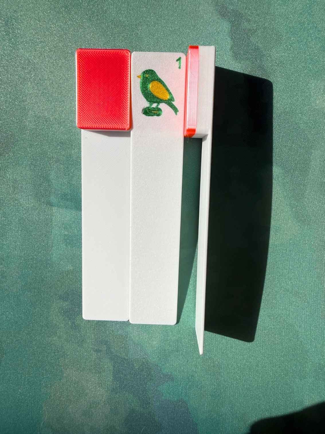A red bookmark of a bam bird