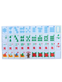 A set of Mahjong tiles arranged in a grid on a plain white background. The tiles feature various winter and holiday designs, including snowflakes, Christmas trees, a Santa Claus tile, a gingerbread man tile, and red poinsettias.