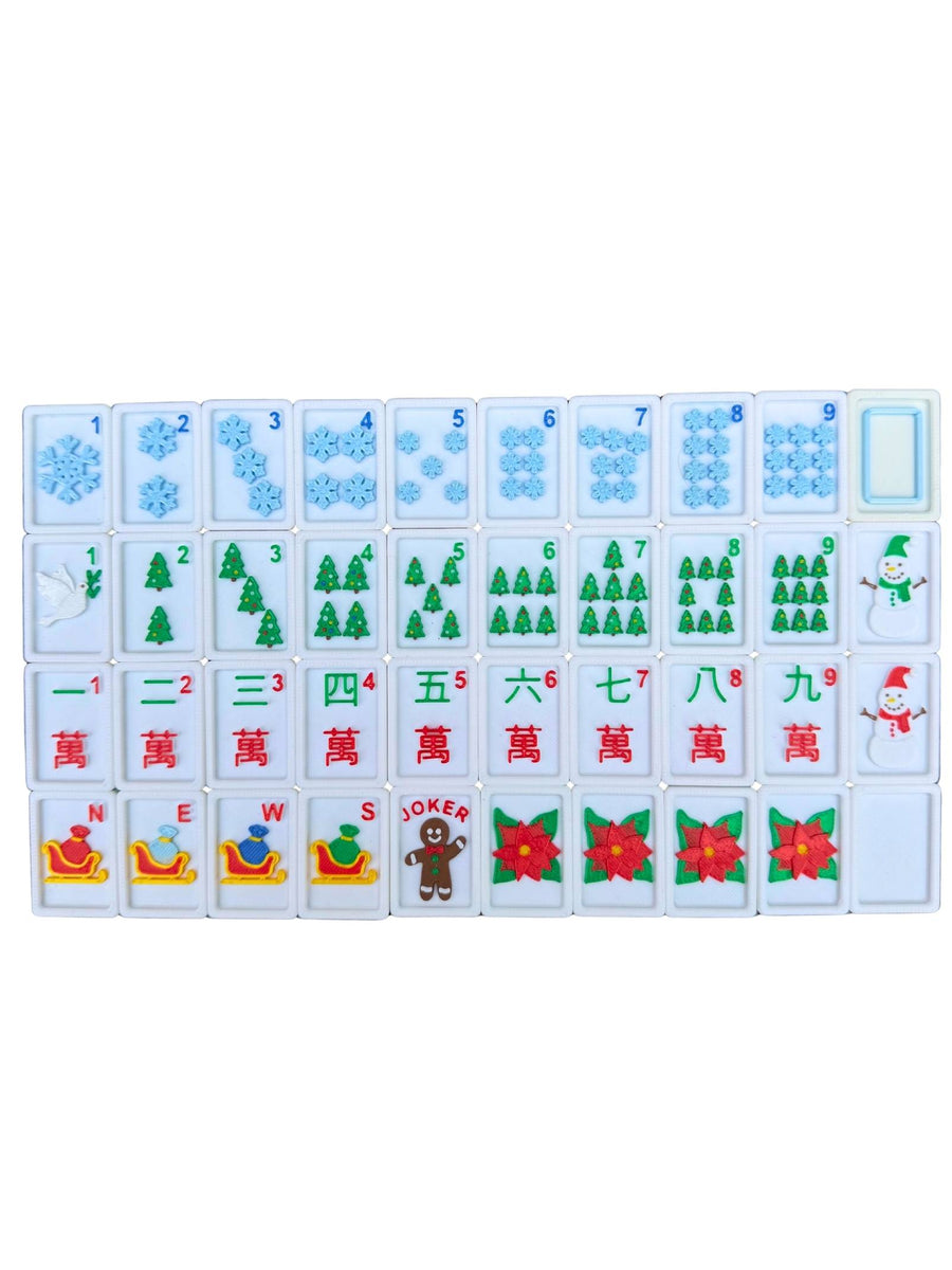 A set of Mahjong tiles arranged in a grid on a plain white background. The tiles feature various winter and holiday designs, including snowflakes, Christmas trees, a Santa Claus tile, a gingerbread man tile, and red poinsettias.