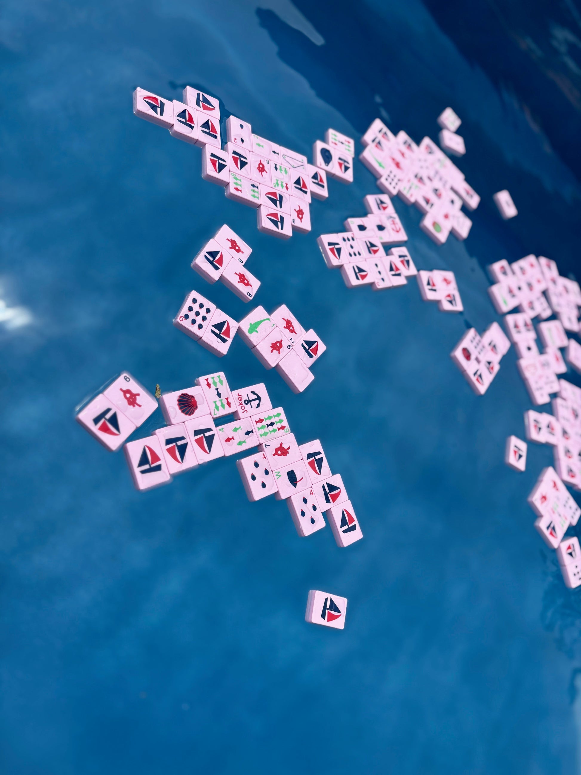 Mahjong tiles scattered on a blue surface
