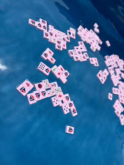 Mahjong tiles scattered on a blue surface