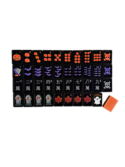 A set of Halloween Travel Mahjong tiles laid out with Pumpkins, Bats, Tombstones, and Skulls