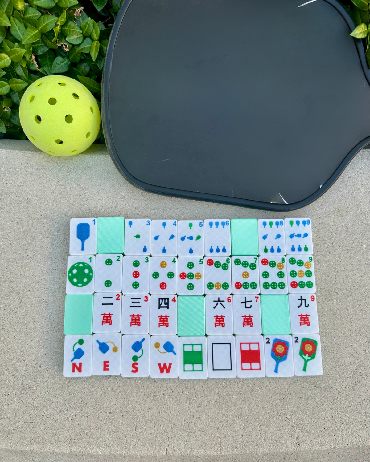 Pickleball-themed Mahjong tiles neatly arranged in a green set with paddles and ball, American Mahjong game by Spools