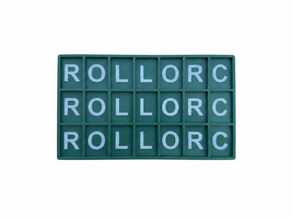 A rectangular green letter board with 18 compartments, each containing a light blue letter, arranged in three rows of six. The letters spell out 'ROLLORC' repeatedly.