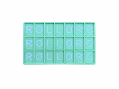 A mint green rectangular grid tray with 15 square compartments, each containing the letters 'ROLL' and 'C' in light blue, arranged to spell 'ROLL OR C' across three rows, isolated on a white background.