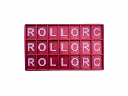 A rectangular red plastic alphabet block board with 20 individual letter compartments, each filled with a pink letter, spelling out 'ROLLORC' vertically three times, isolated on a white background.
