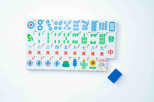 A set of Mahjong tiles arranged in a grid on a white background, with a small blue tile placed separately at the lower right.