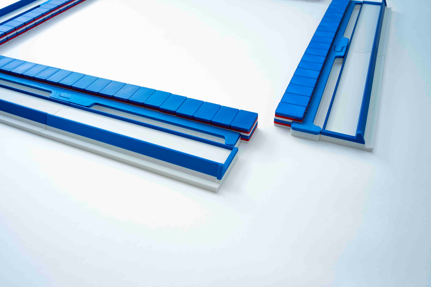 Blue and white rectangular mahjong components arranged on a clean white studio background.