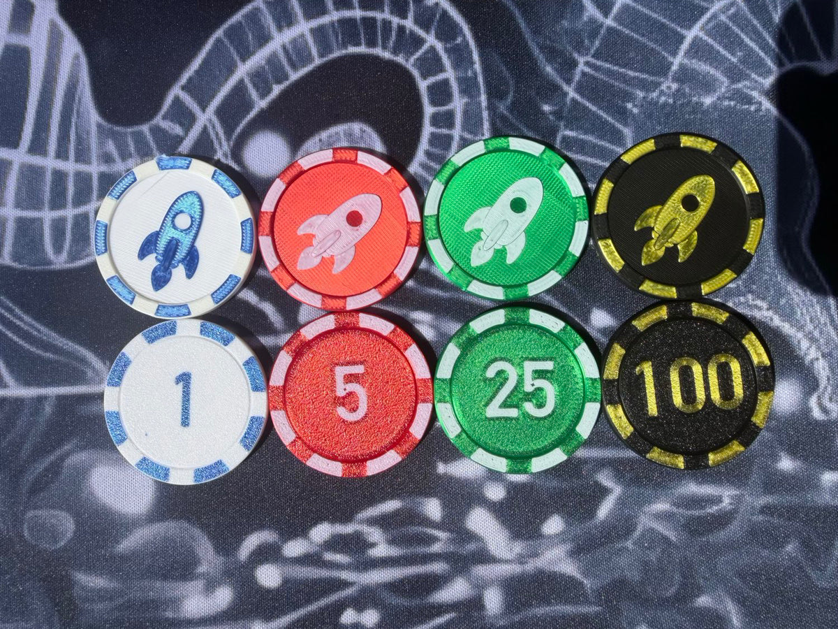 Eight rocket-themed gaming chips in different denominations (1, 5, 25, 100) arranged in a grid on a dark patterned background.