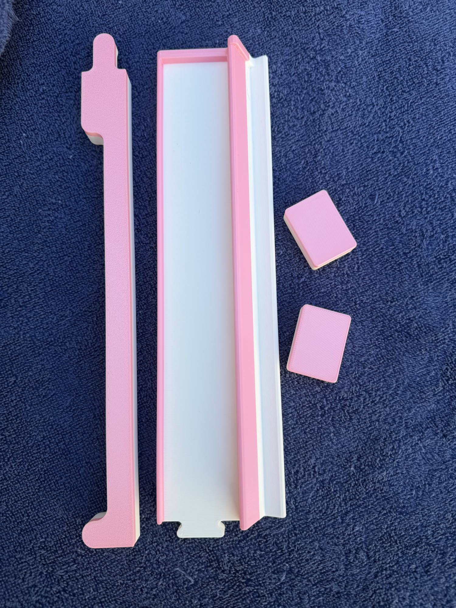 Close-up of Spools Pink Compass mahjong racks showing slim, lightweight pink rack design.

