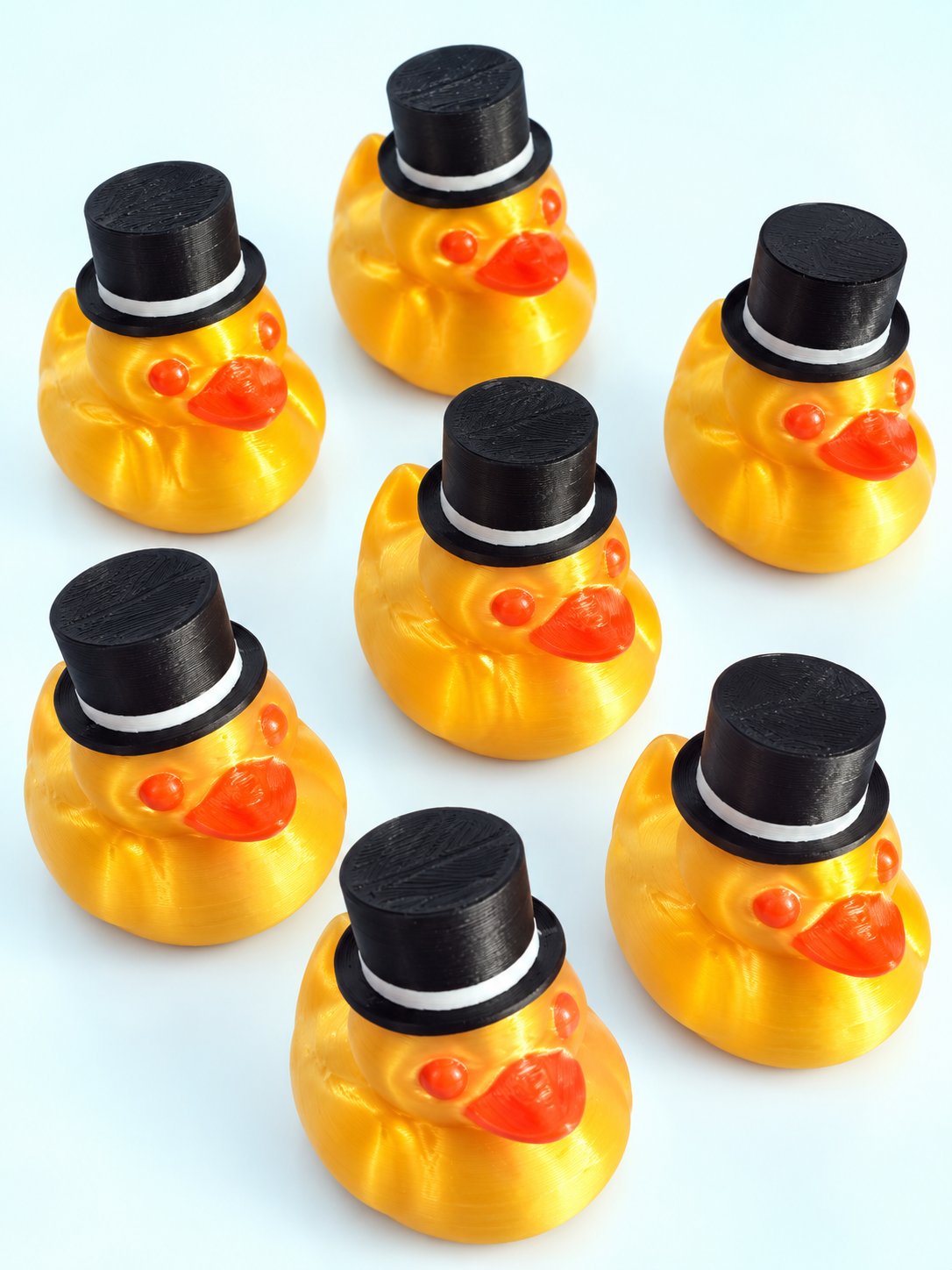 Group of 3D-printed ducks in top hats, mahjong trinkets from Spools