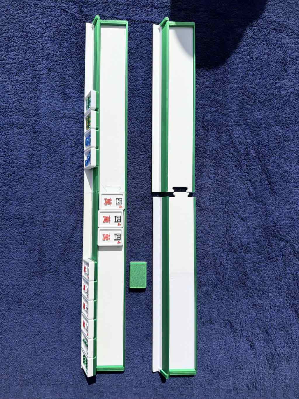 a set of travel mahjong racks with mahjong tiles