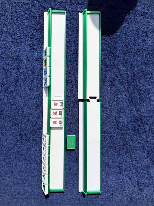 a set of travel mahjong racks with mahjong tiles