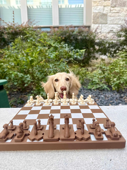 Brown and cream Wiener Dog Chess set on a chessboard with a real dachshund in the background.