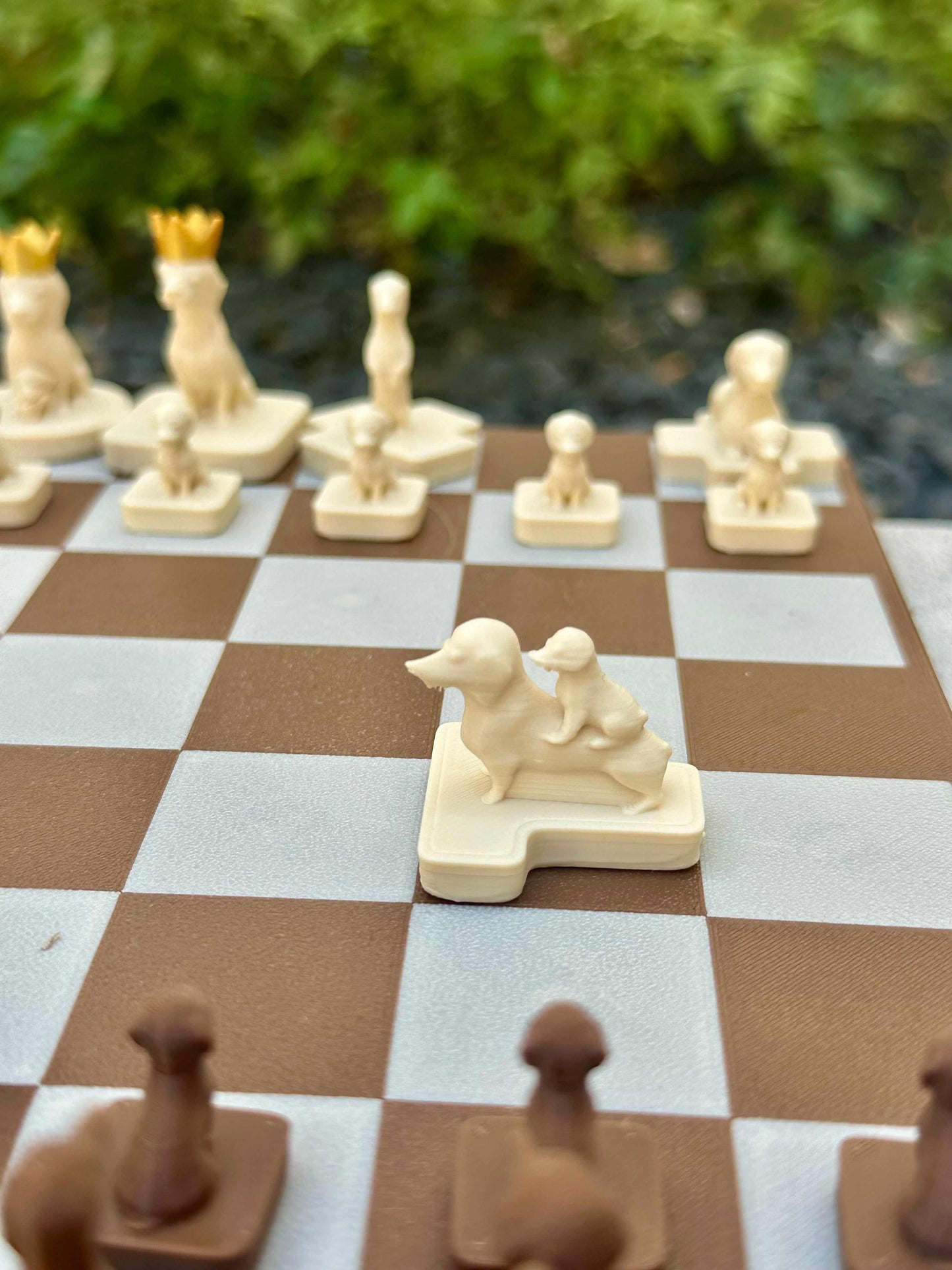 Close-up of cream dachshund knight chess piece from the Wienerdog Chess set on a brown and white chessboard
