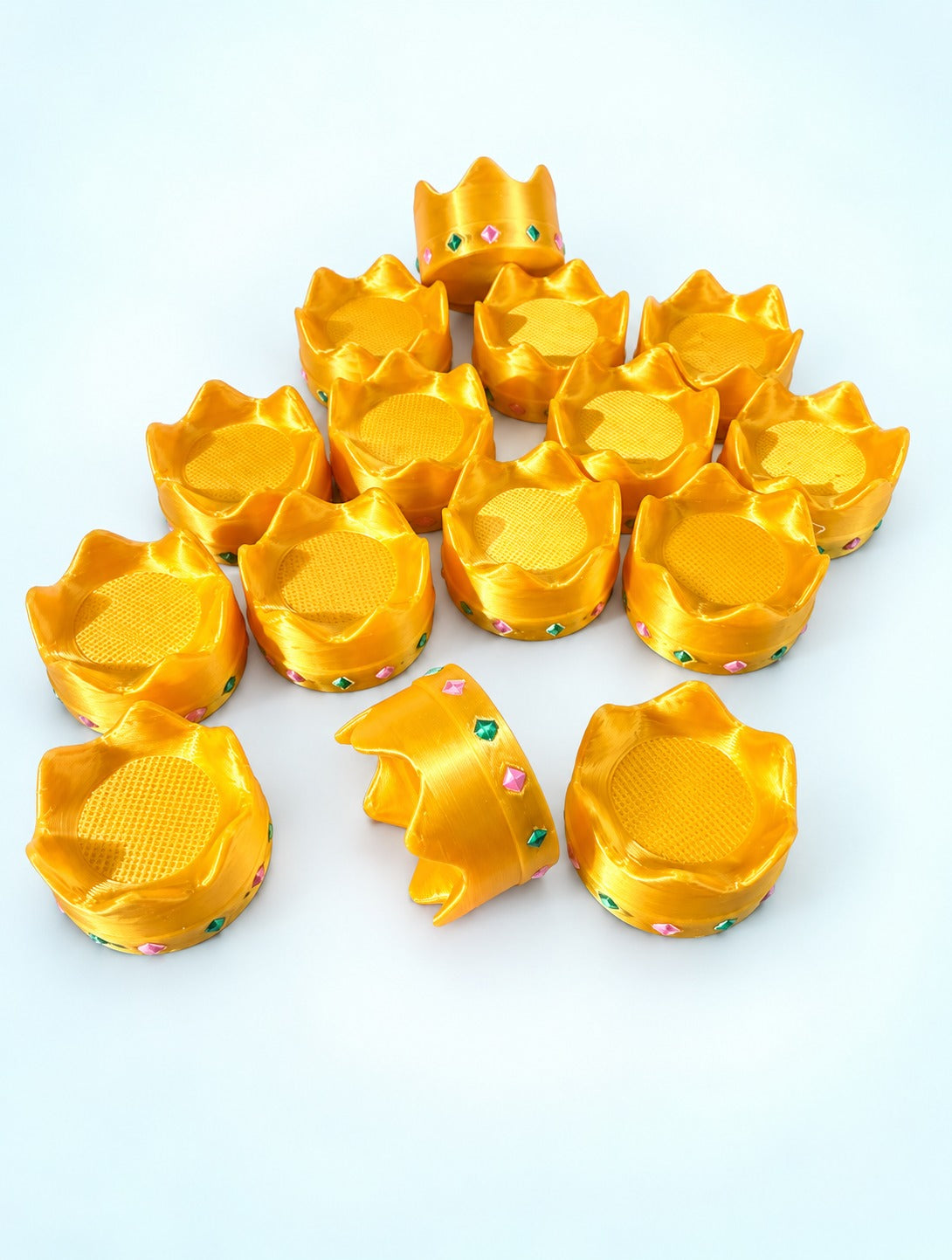 Gold crown mahjong trinkets with pink and green gem details, 3D printed by Spools