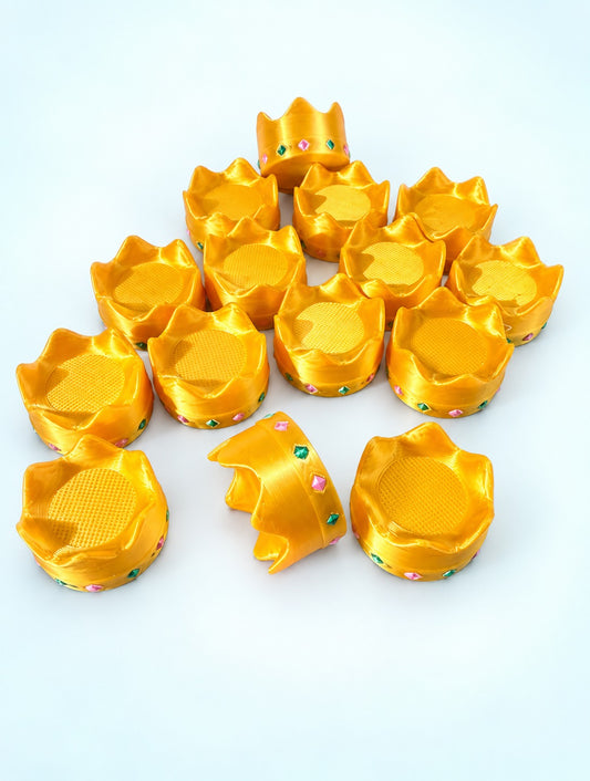 Gold crown mahjong trinkets with pink and green gem details, 3D printed by Spools