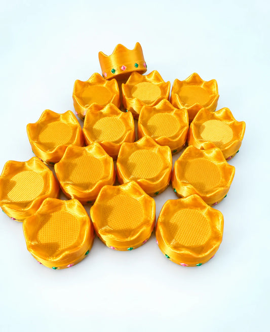 Pile of gold crown mahjong trinkets on a white background