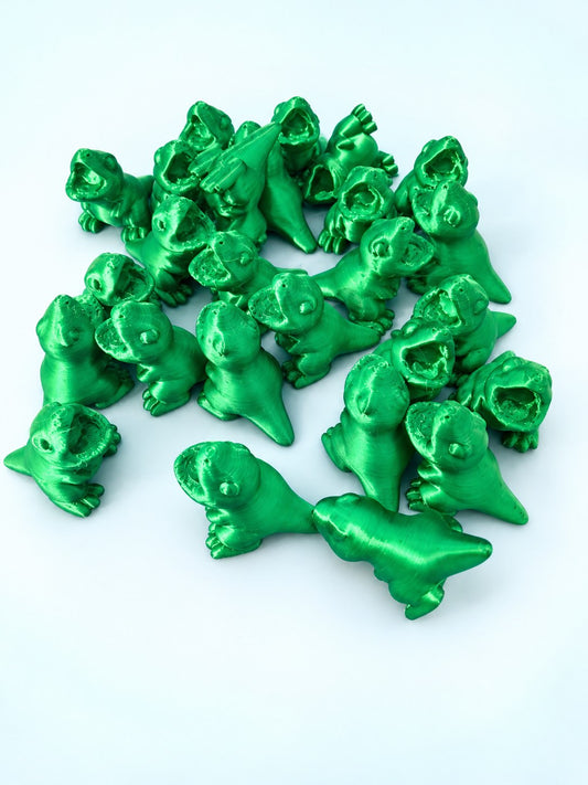 Pile of green baby dinosaur mahjong trinkets with open mouths, 3D printed by Spools