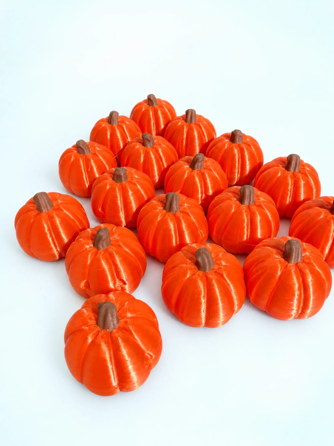 Group of orange pumpkin mahjong trinkets on a white background