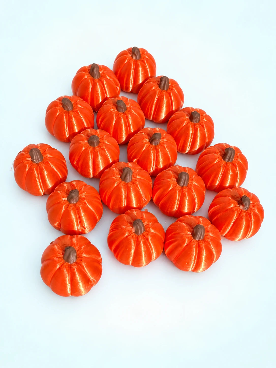 Set of 3D-printed pumpkin mahjong trinkets with brown stems