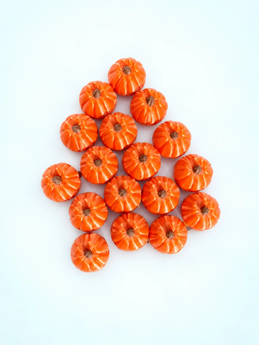 Top view of pumpkin mahjong trinkets arranged in a triangle