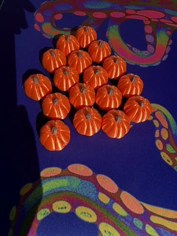 Orange pumpkin mahjong trinkets on a purple mahjong mat