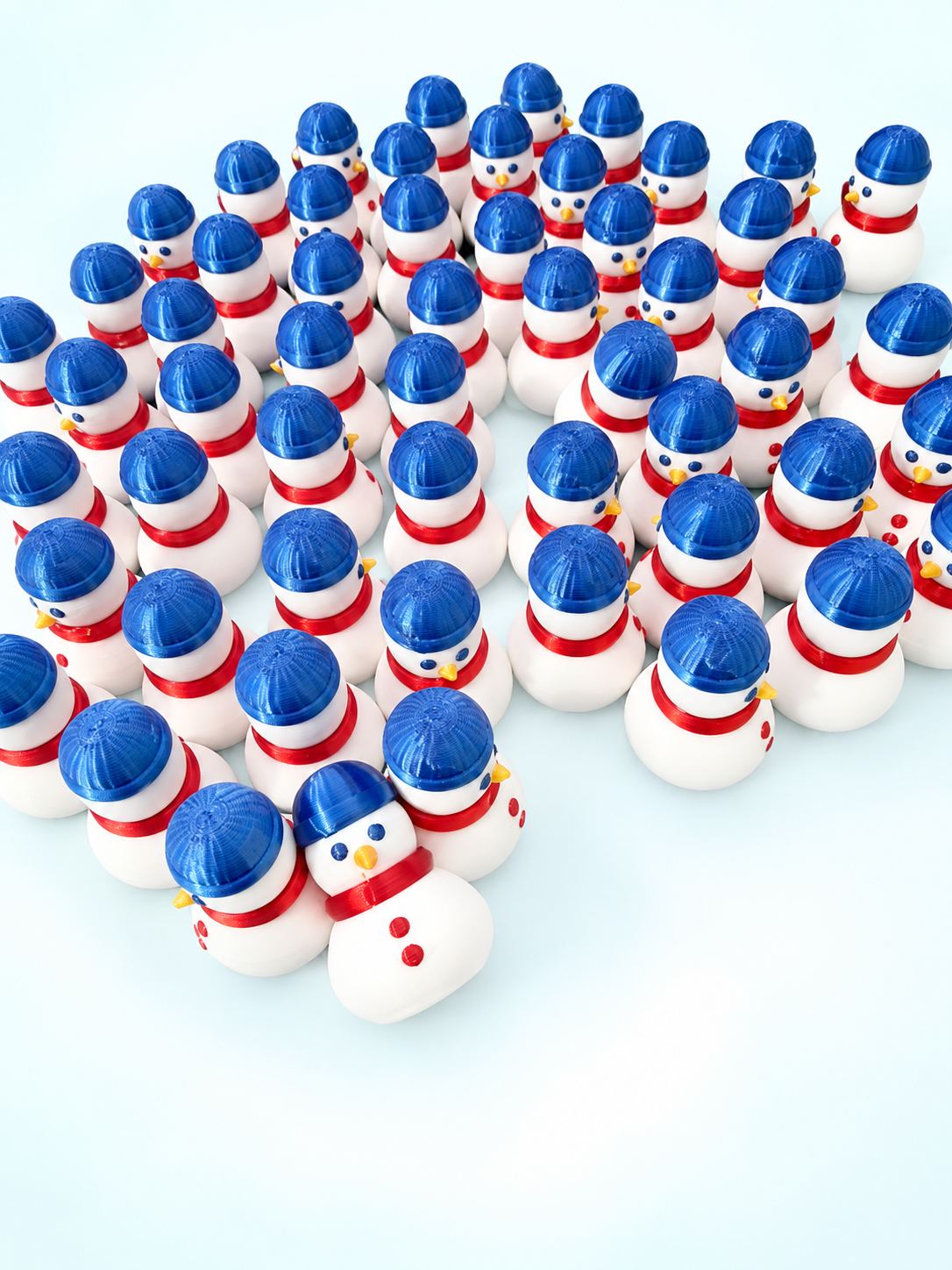 Group of 3D-printed snowman mahjong trinkets from Spools with blue beanies and red scarves