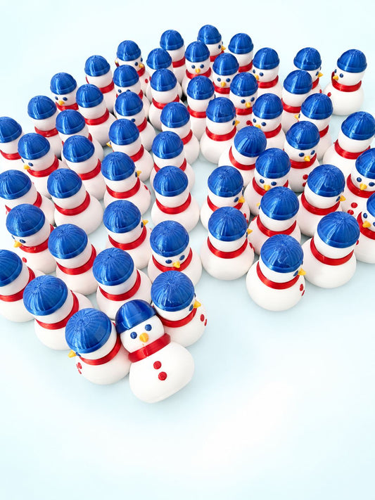 Group of 3D-printed snowman mahjong trinkets from Spools with blue beanies and red scarves