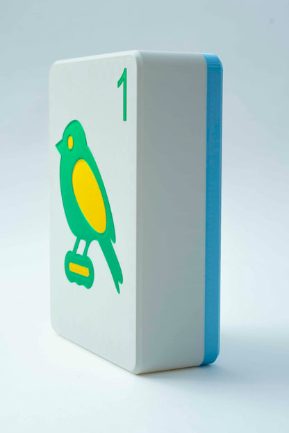 Spools mega mahjong tile display case with a light blue back and white face showing the 1 bam bird, on a light gray background
